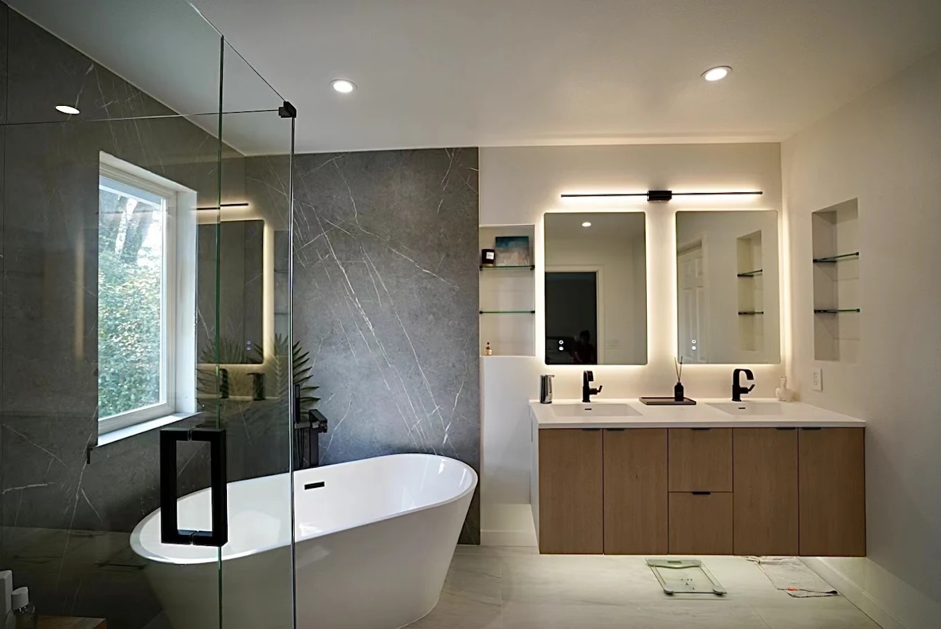 Remodeled bathroom with freestanding tub and glass walk-in shower in Bellevue, WA
