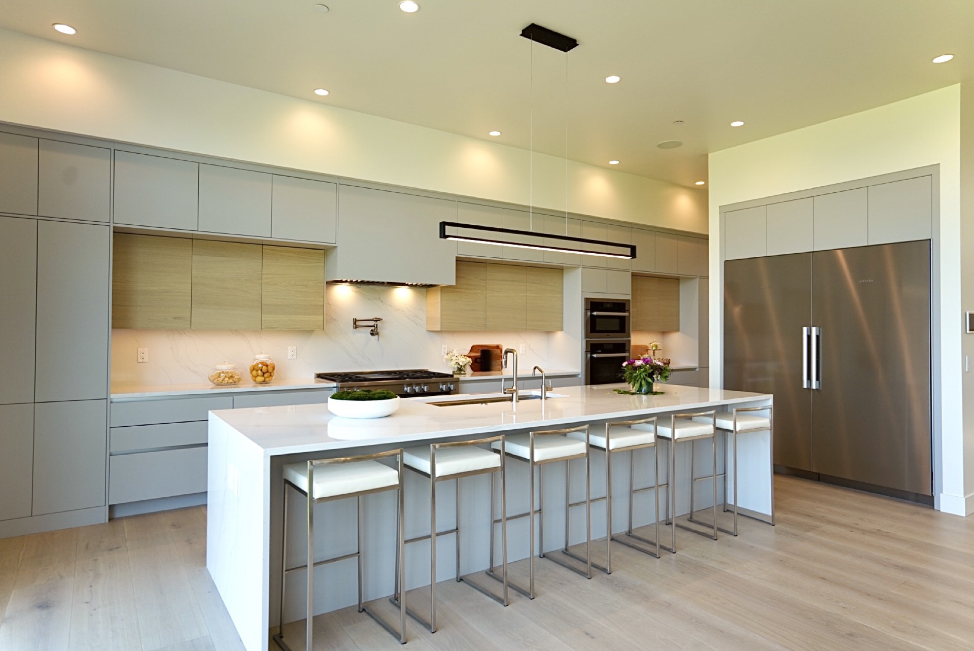Newly remodeled open-concept kitchen with white cabinetry and hardwood floors in Bellevue, WA